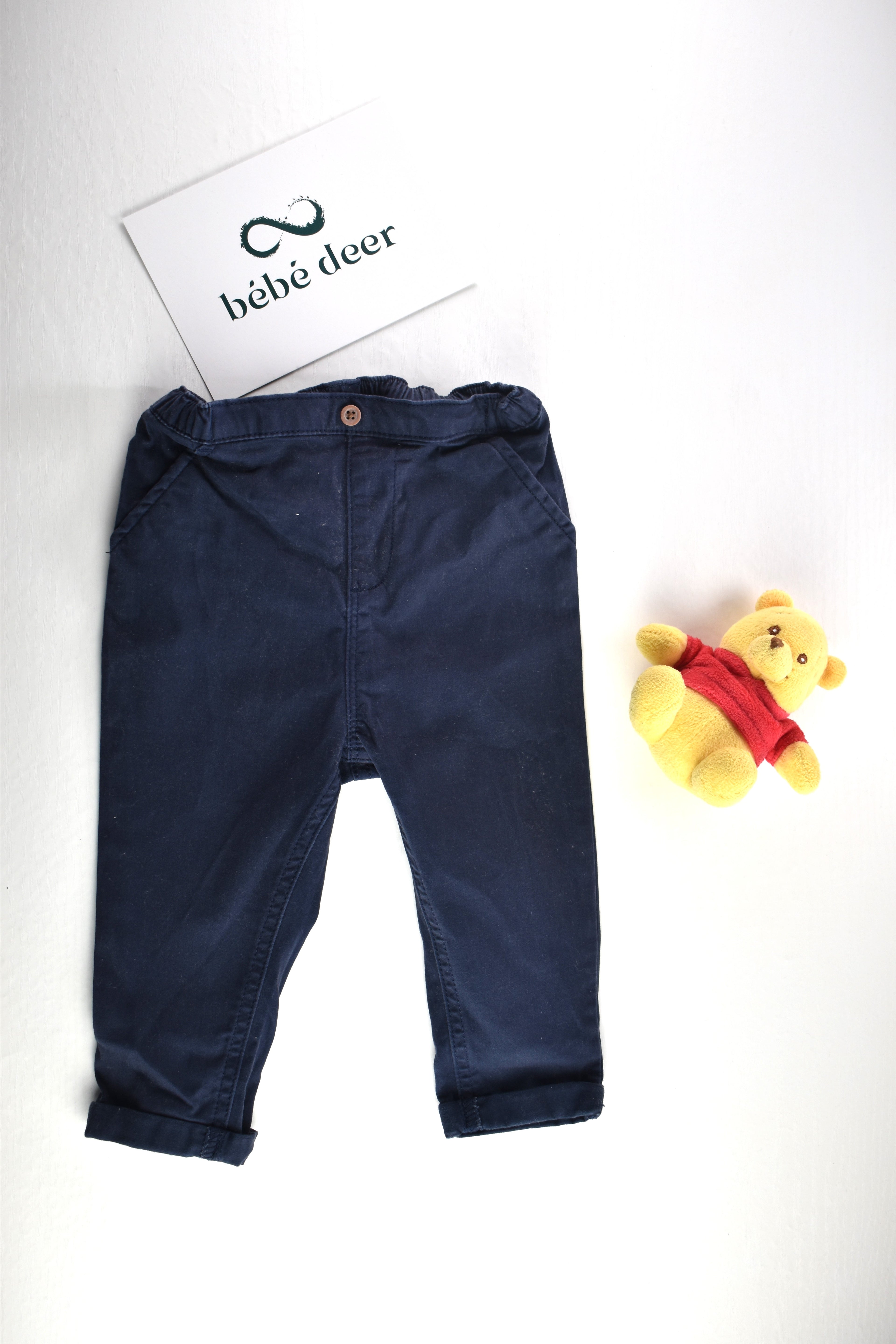 Navy trousers with a decorative button