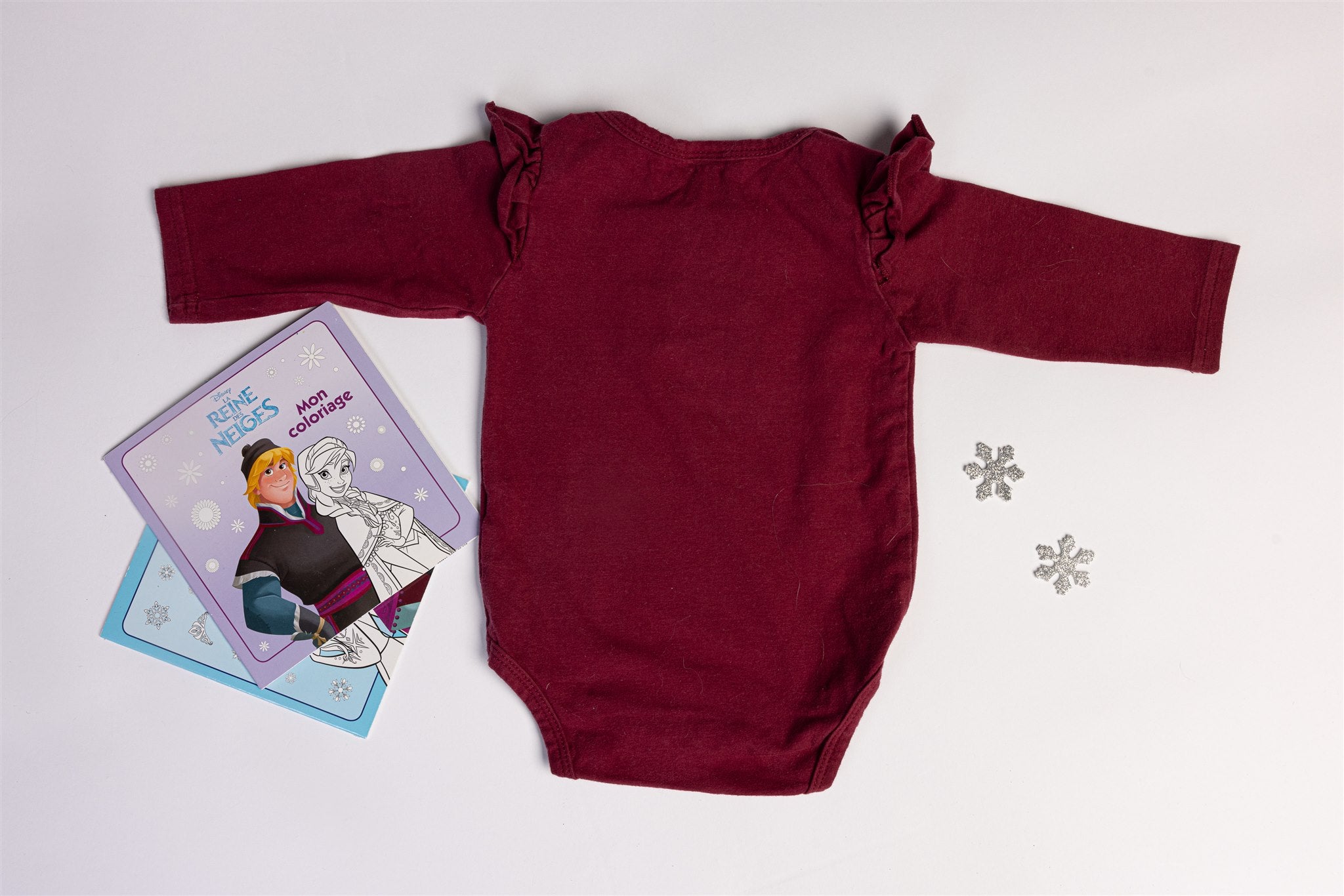 Burgundy bodysuit with decorative buttons