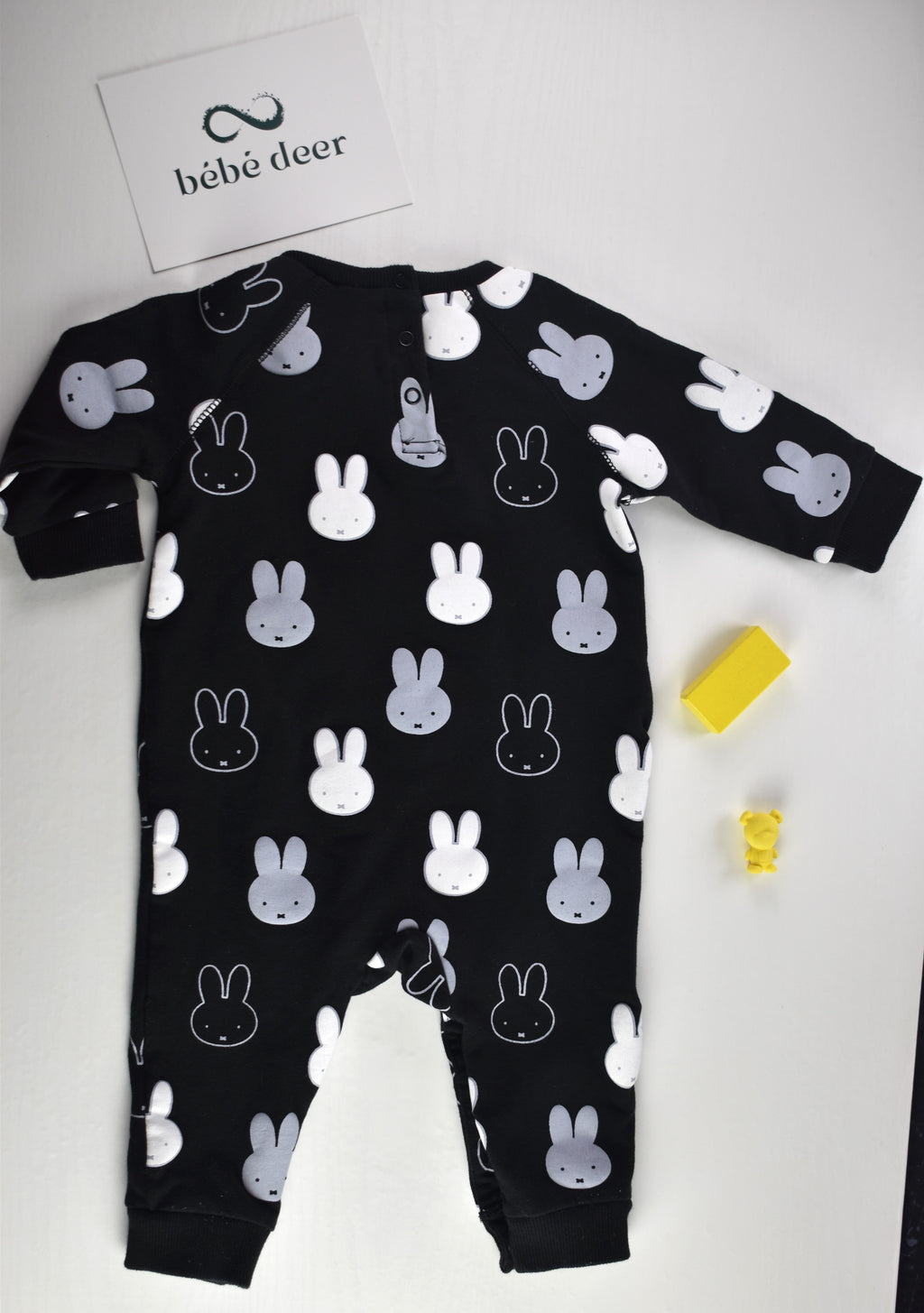 Black sleepsuit with an all-over white and grey Miffy rabbit print