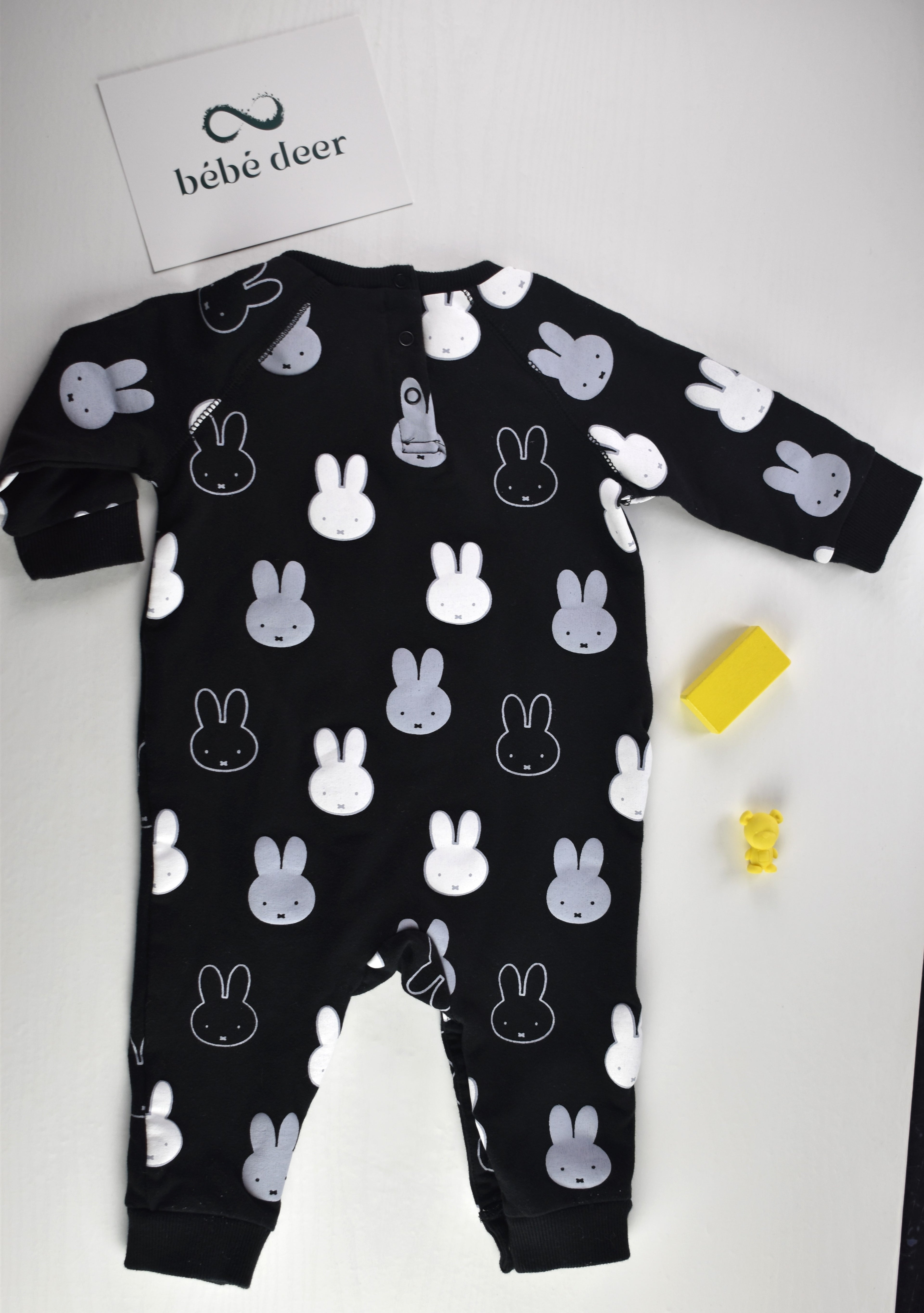 Black sleepsuit with an all-over white and grey Miffy rabbit print