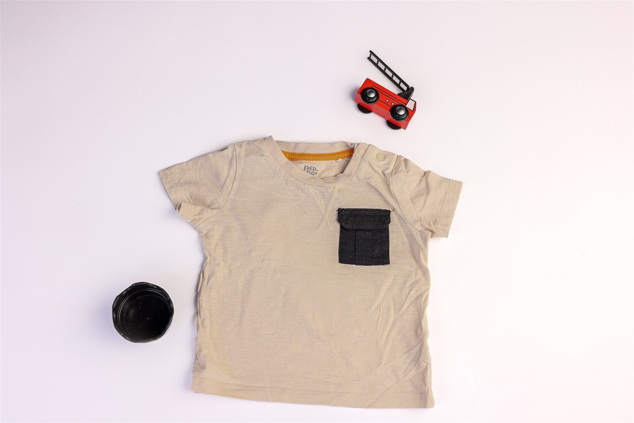 Beige top with a small black pocket