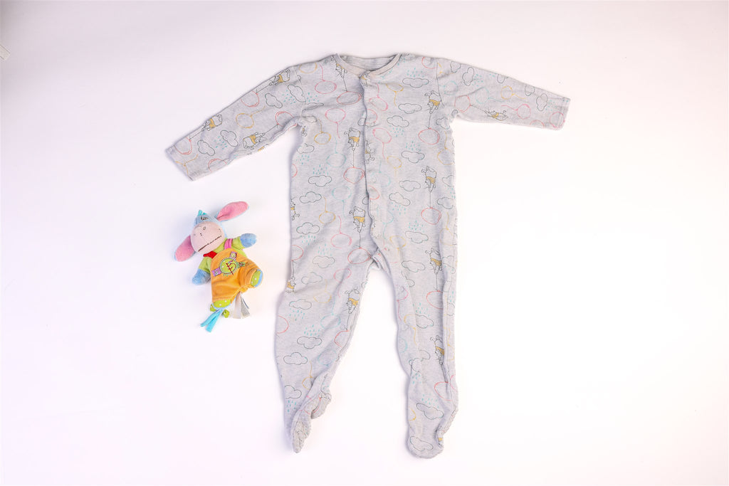 Winnie the Pooh sleepsuit with balloons and clouds and snap buttons on the front