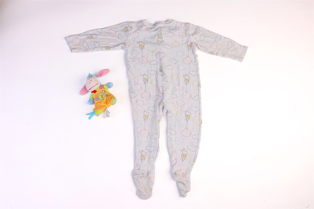 Winnie the Pooh sleepsuit with balloons and clouds and snap buttons on the front