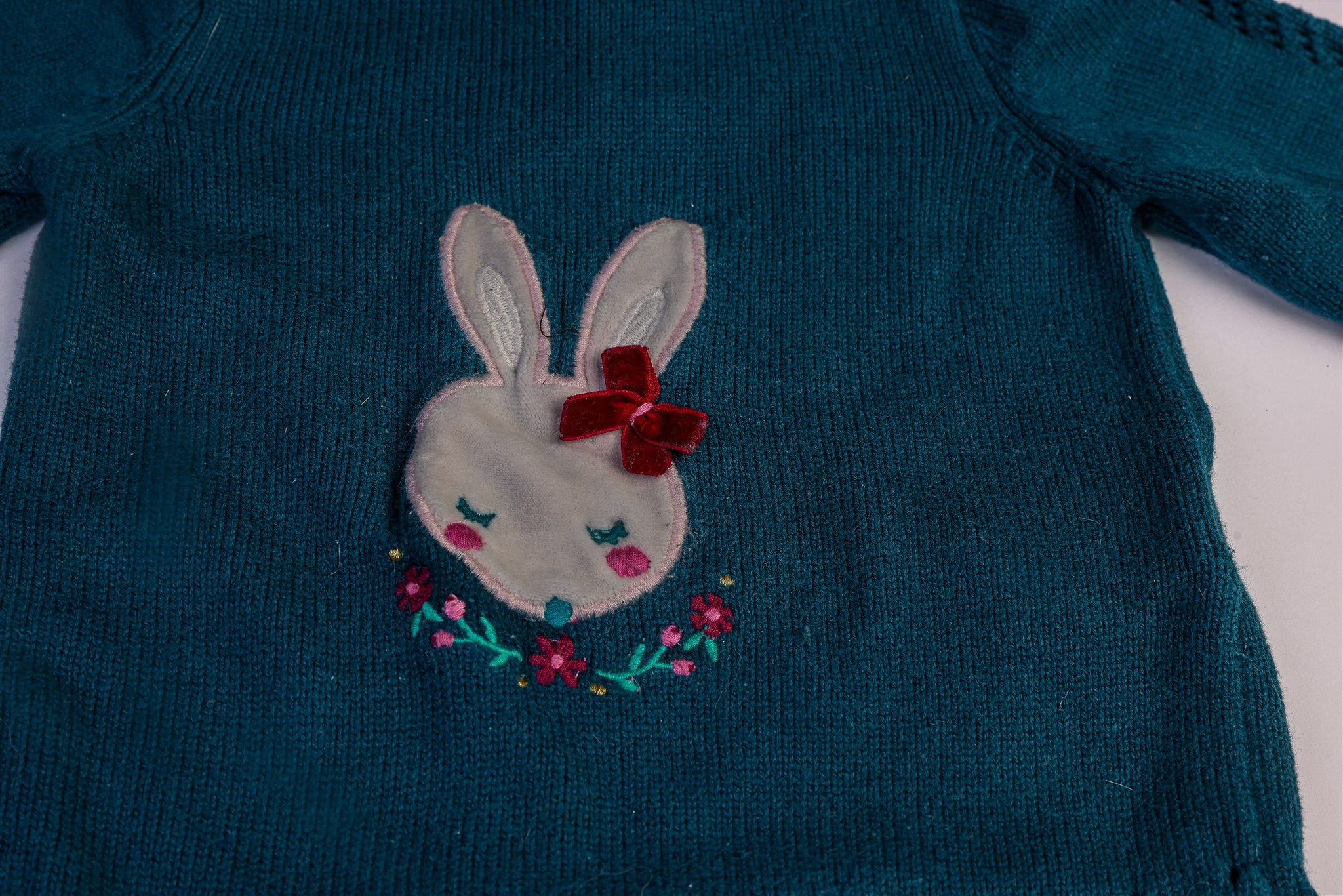 Green jumper with white rabbit and flowers