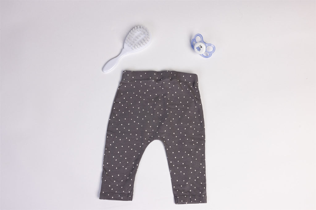 Light grey trousers with white polka dots