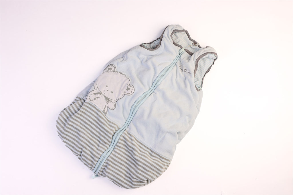 Blue and striped hem sleeping bag with a small teddy bear