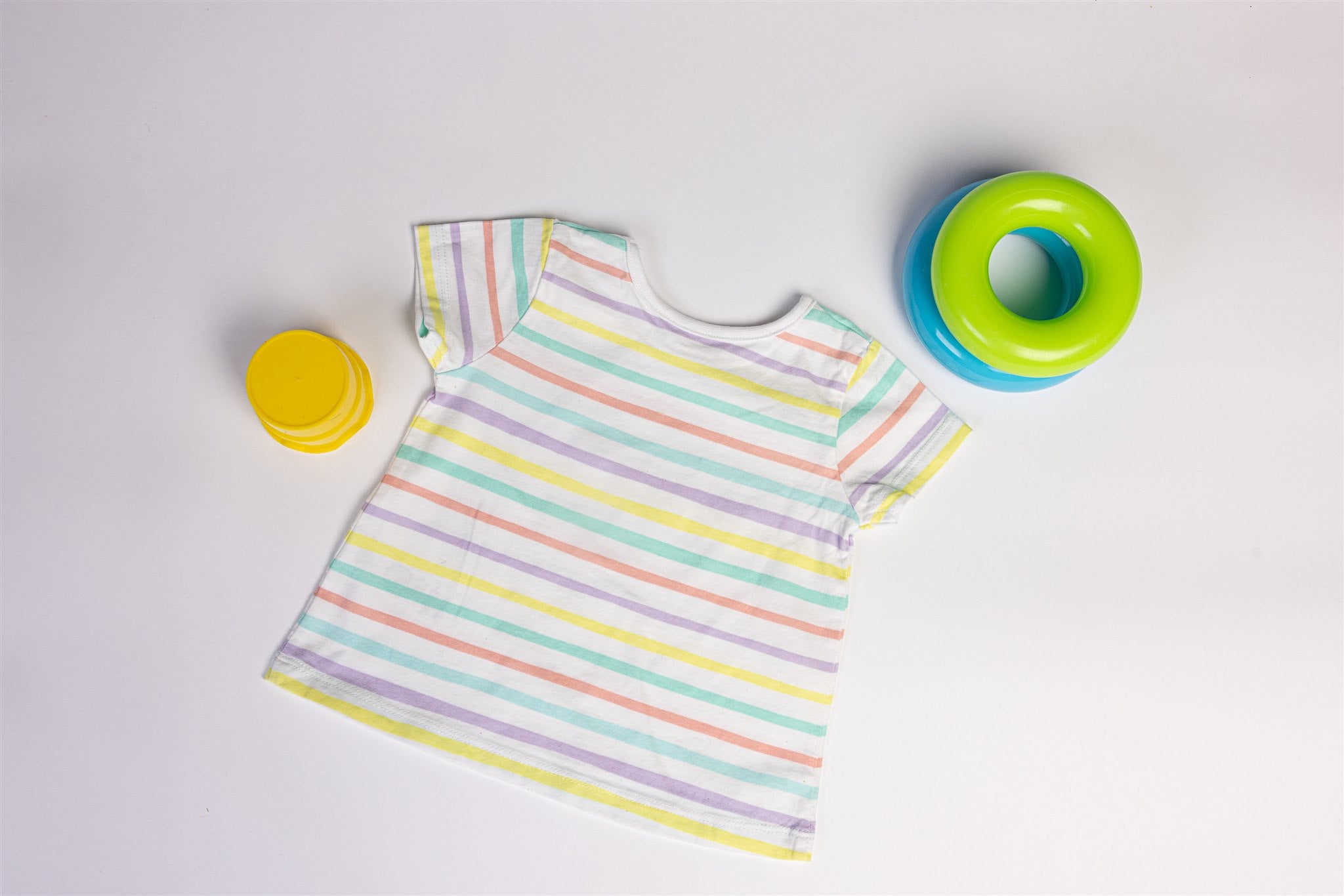 White top with yellow, salmon, and green stripes