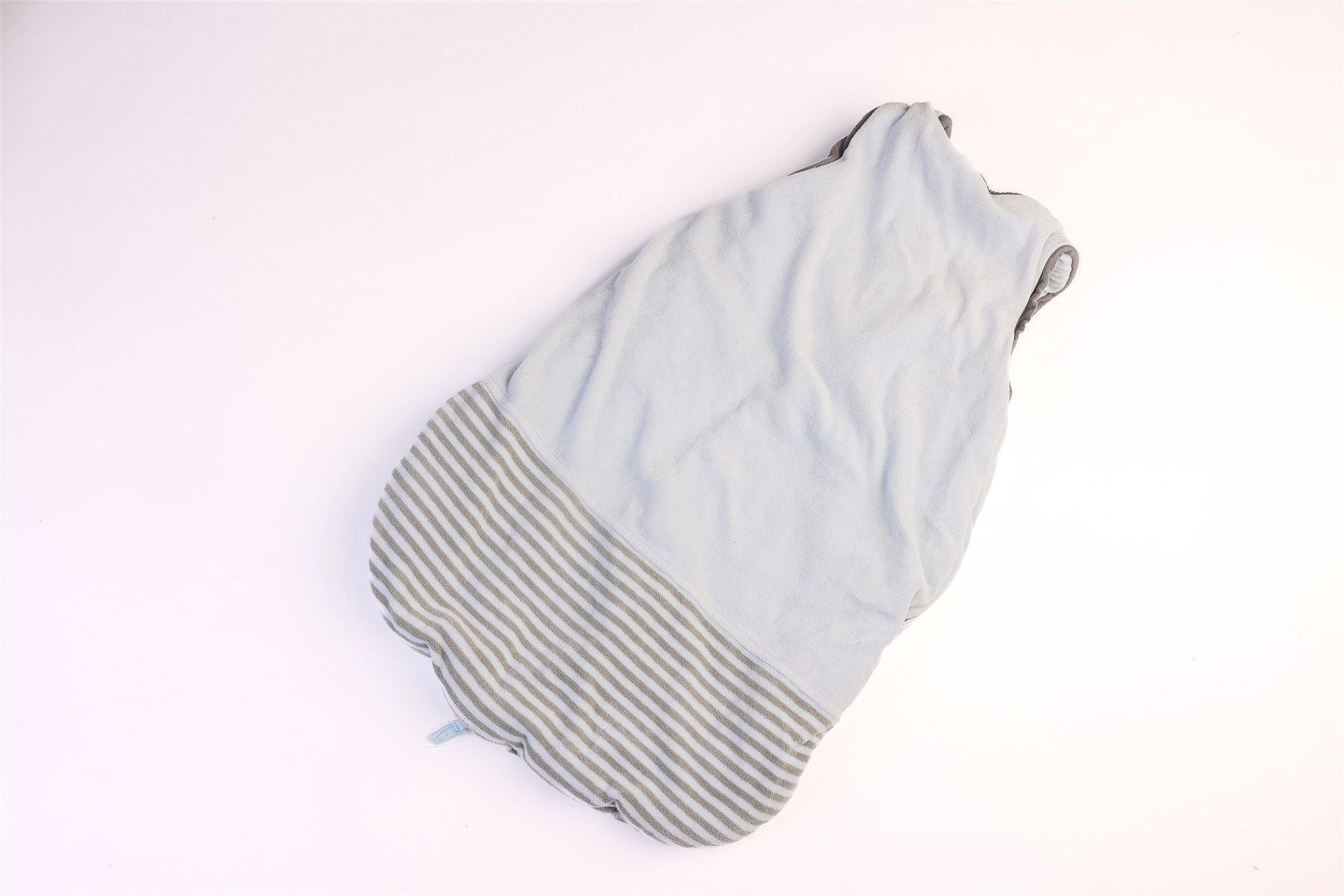 Blue and striped hem sleeping bag with a small teddy bear