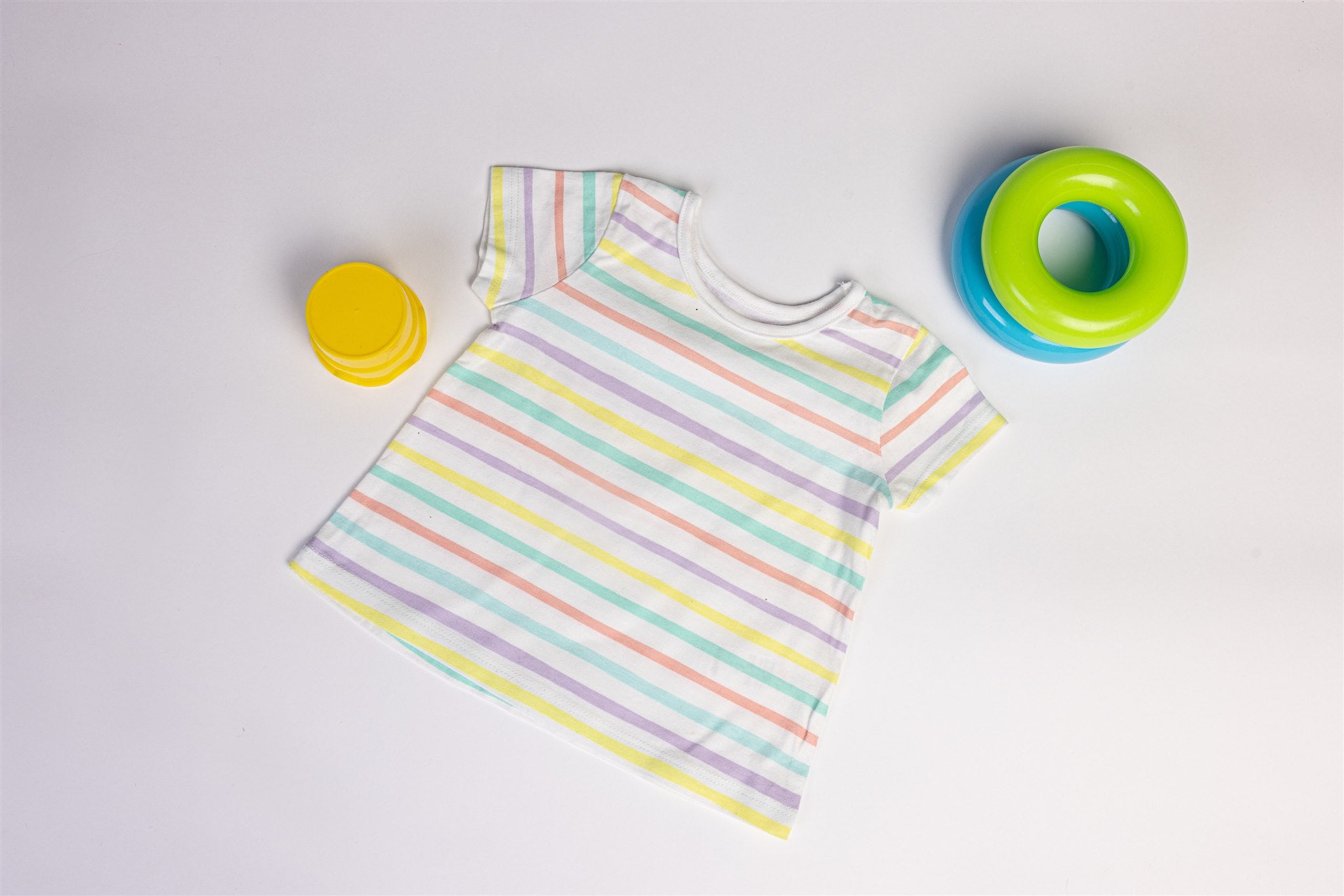 White top with yellow, salmon, and green stripes