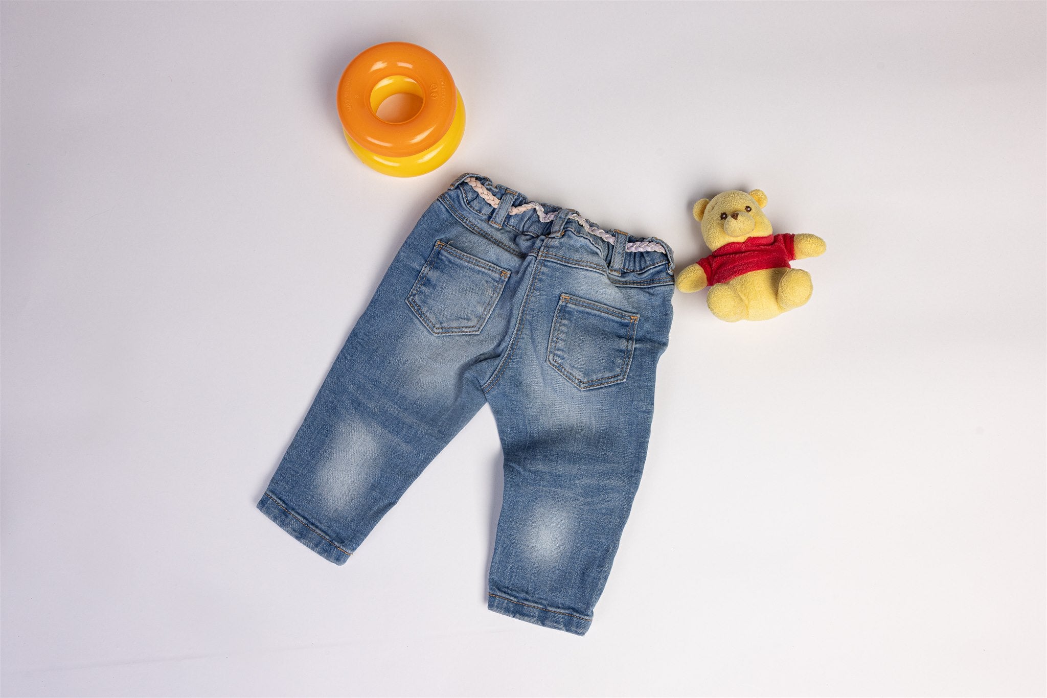 Jeans with decorative pink and purple waistband