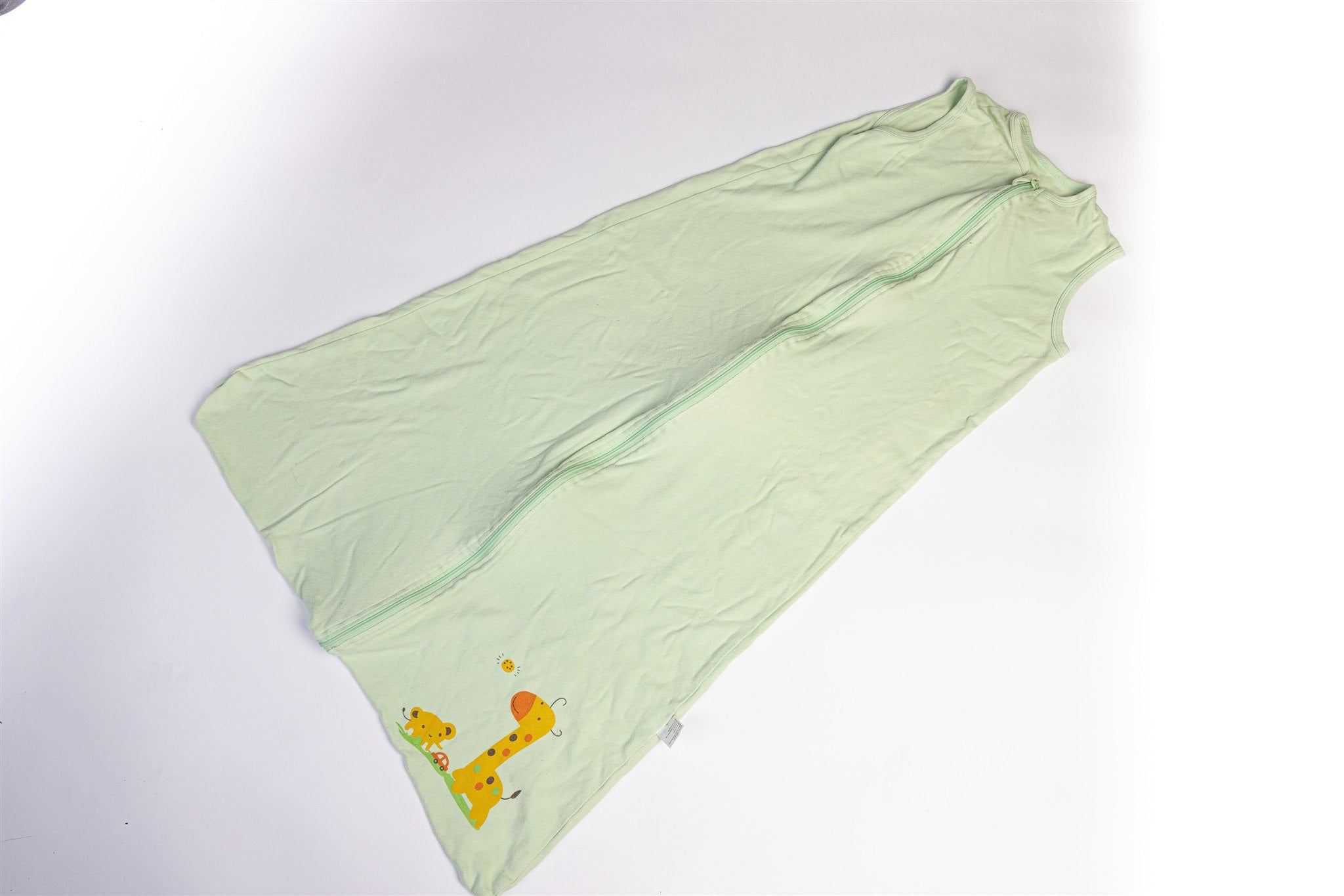 Green sleeping bag with giraffe