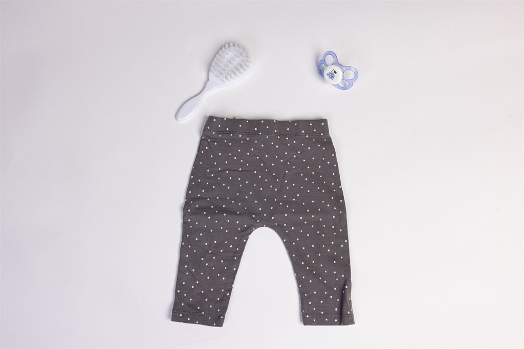 Light grey trousers with white polka dots