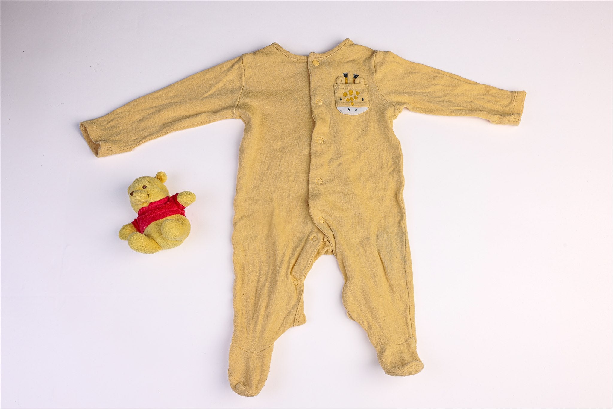 Yellow sleepsuit with a giraffe head