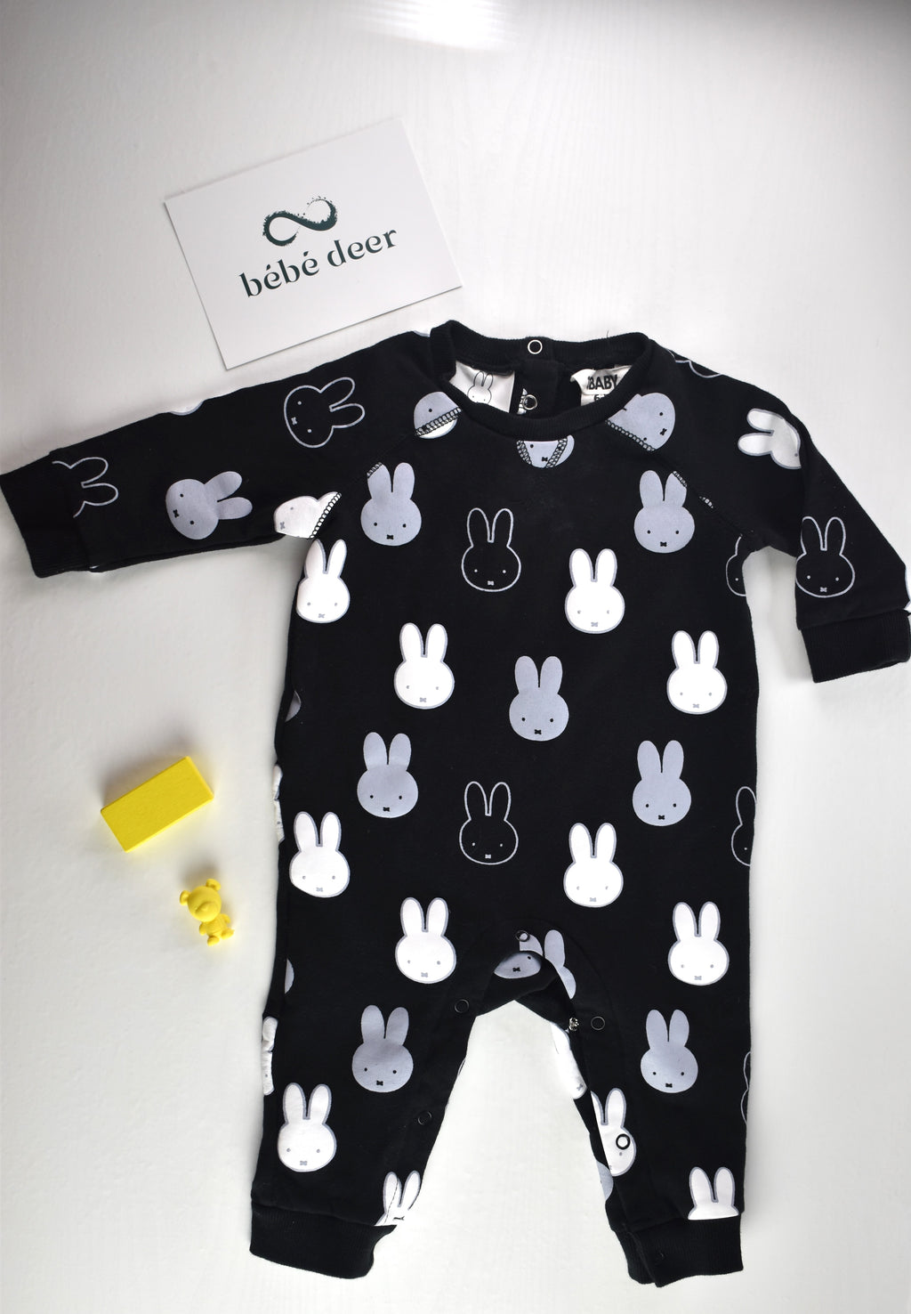 Black sleepsuit with an all-over white and grey Miffy rabbit print