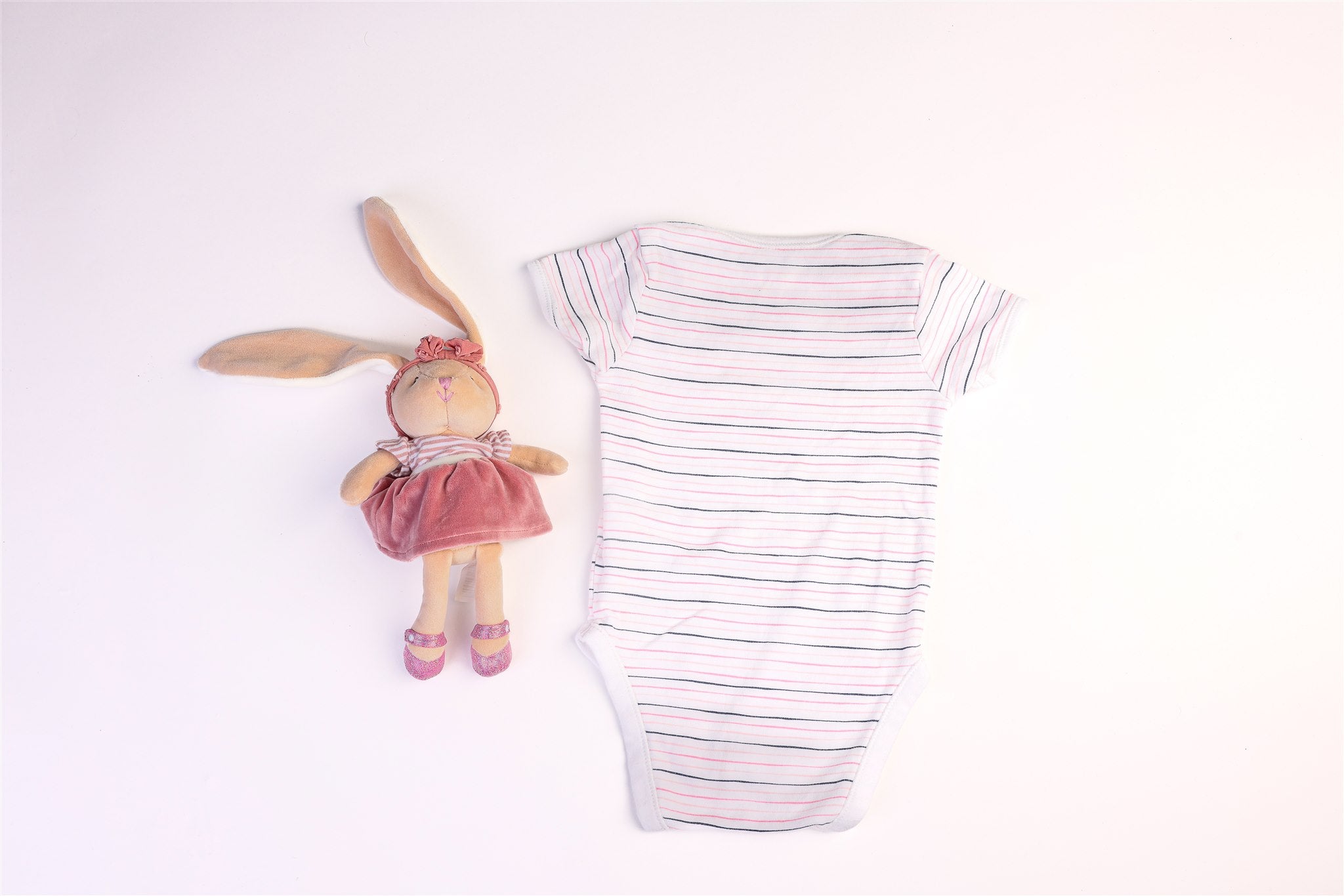 Short-sleeved bodysuit with white, black, and pink stripes